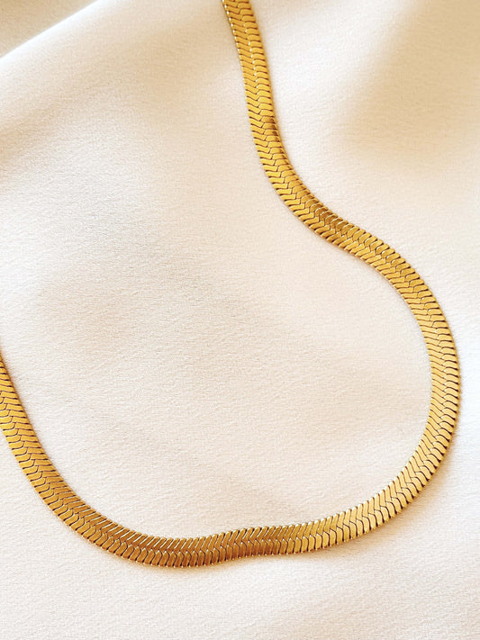 Timeless and chic, the Gold Plated Herringbone Large Necklace is crafted in 14K gold plated, that sits elegantly on the collar bone. Inspired by timeless, classic pieces updated for modern day accessorising. Our snake chains are a delicate piece of jewellery that have been lovingly hand-crafted and they need the same level of care from you so they can be loved for years to come. 